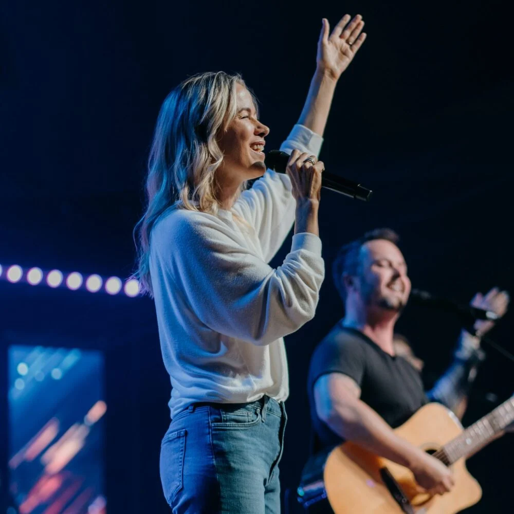 A worship leader sings at New Day Church
